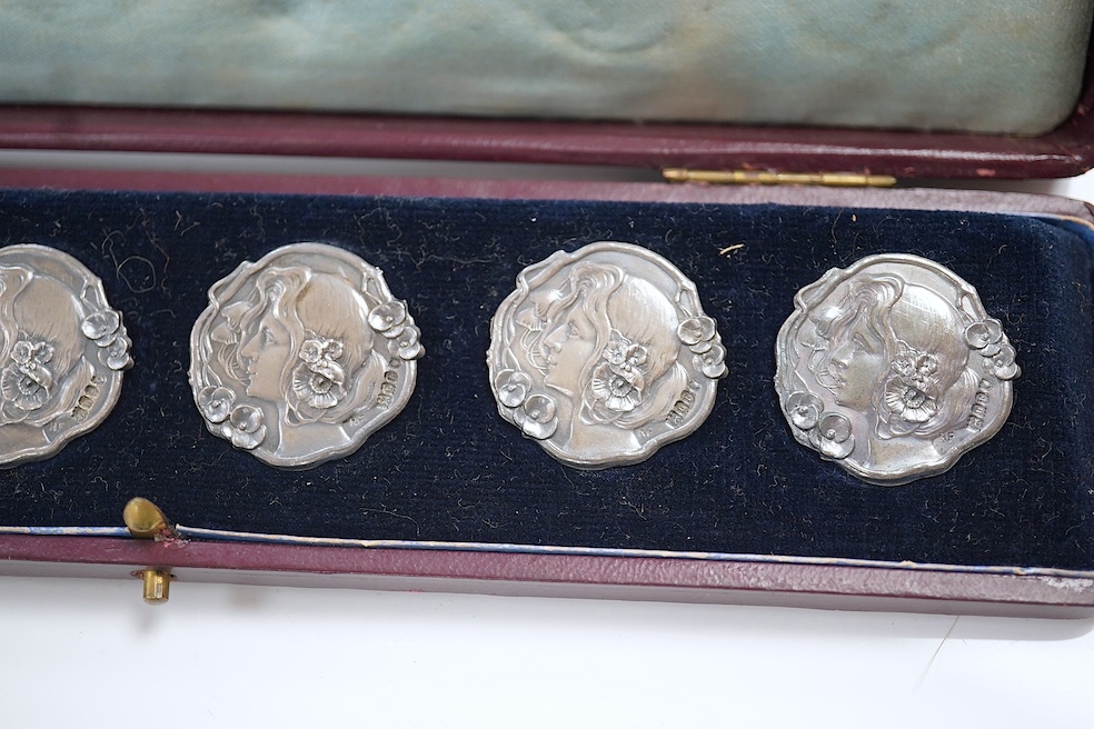 A cased set of six Edwardian Art Nouveau silver buttons, decorated with the head of a lady, import marks for Robert Friederich, London, 1902, 24mm. Condition - fair to good